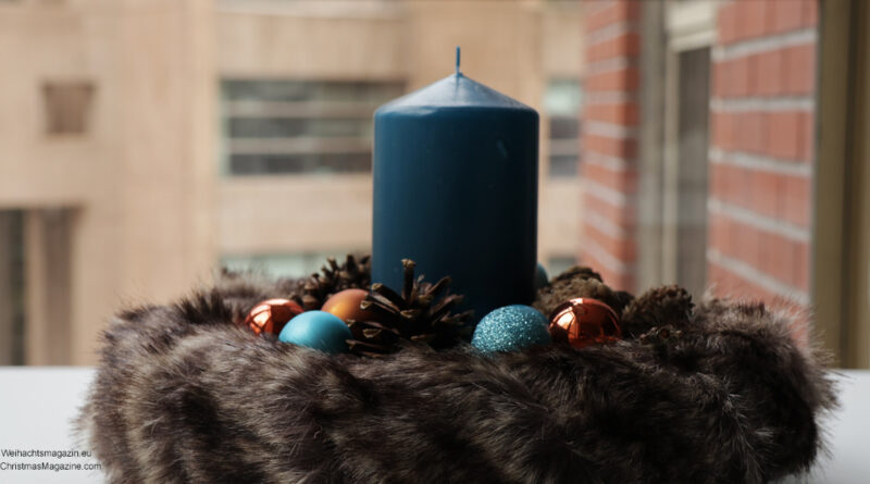 blue candle in fur wreath